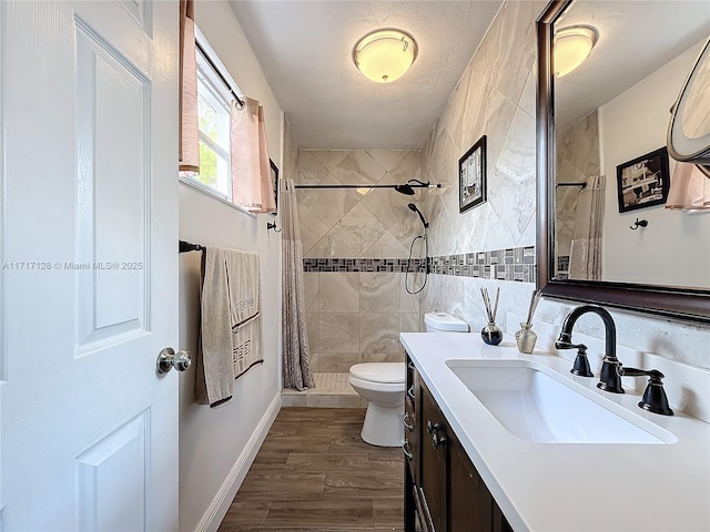 bathroom with vanity, a shower with shower curtain, toilet, tile walls, and wood-type flooring