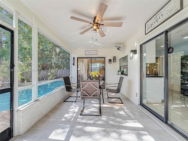 sunroom / solarium featuring ceiling fan and a wealth of natural light