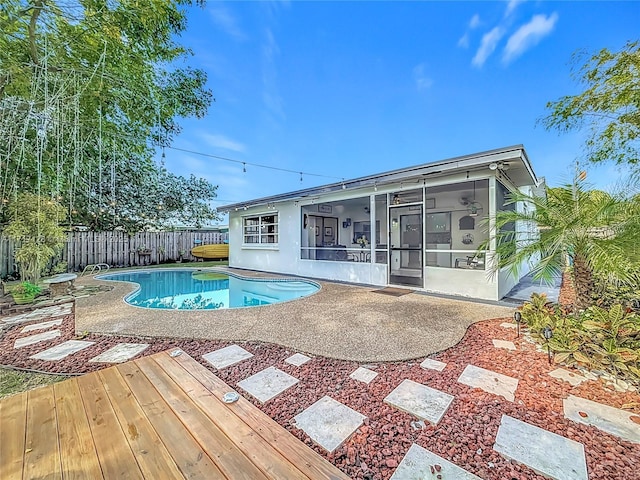 view of pool featuring a sunroom and a patio