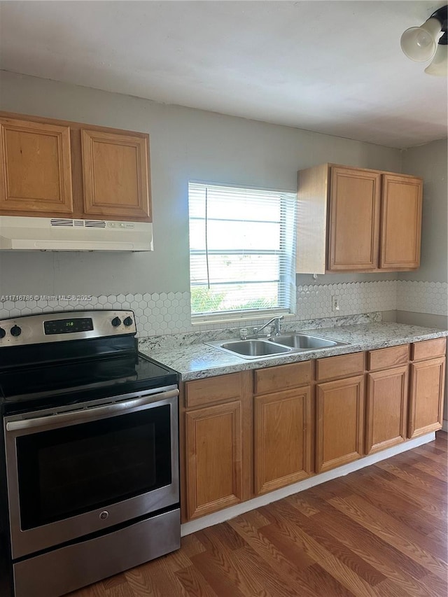 kitchen with sink, tasteful backsplash, light stone counters, dark hardwood / wood-style flooring, and electric stove