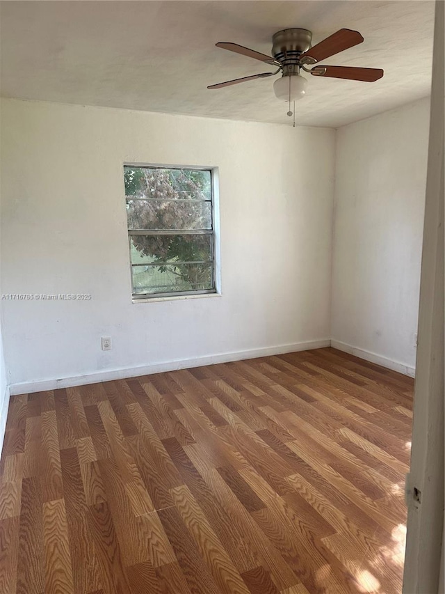 spare room with ceiling fan and hardwood / wood-style flooring