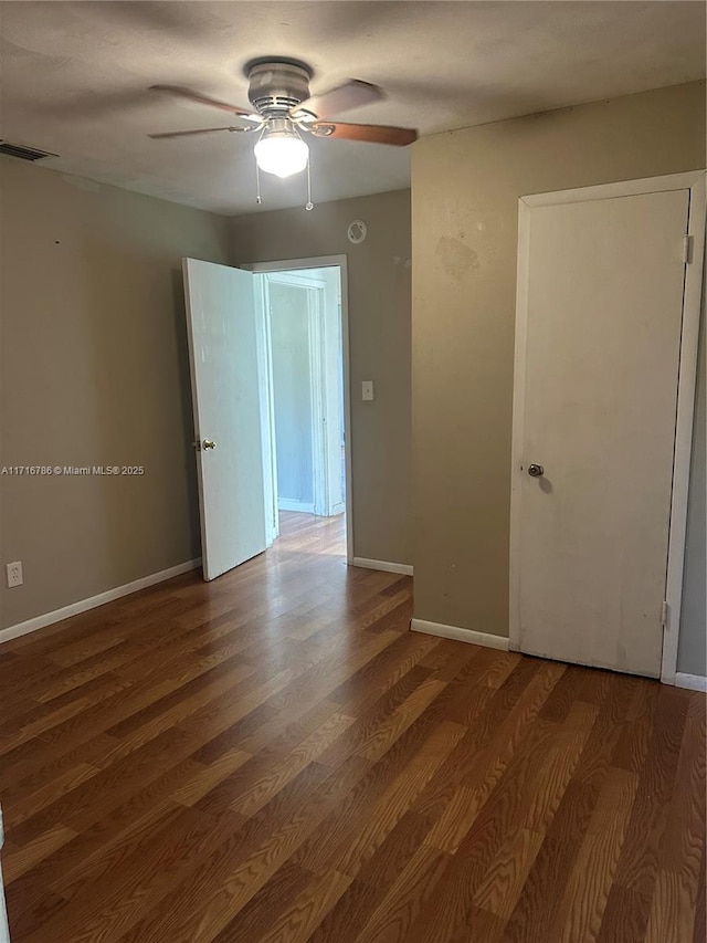 spare room featuring ceiling fan and hardwood / wood-style floors