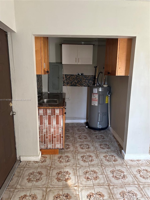 kitchen with electric water heater, sink, and electric panel