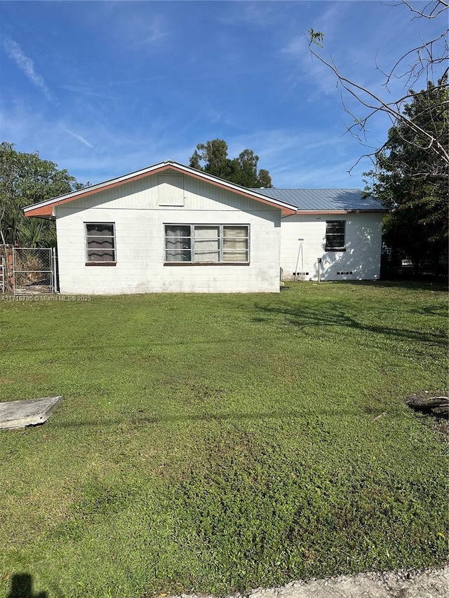 view of side of home featuring a lawn