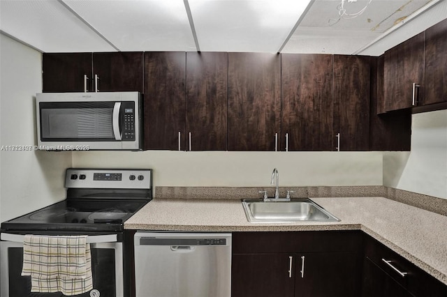 kitchen with dark brown cabinets, sink, and appliances with stainless steel finishes