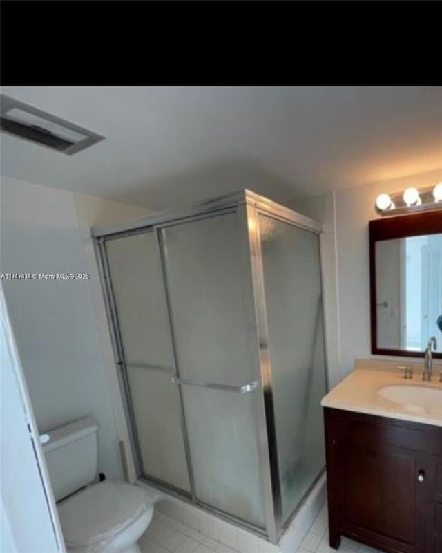 1020 94th St Unit 203, Bay Harbor Islands, FL 33154 - bathroom featuring vanity, toilet, and an enclosed shower