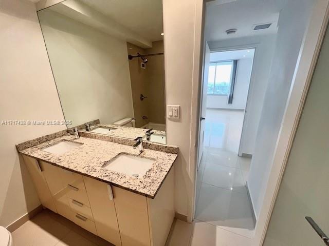 bathroom featuring walk in shower, tile patterned floors, vanity, and toilet