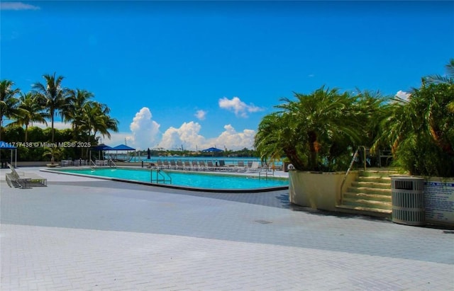 view of swimming pool with central AC unit