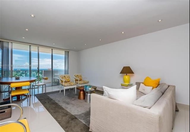 living room with expansive windows and tile patterned floors