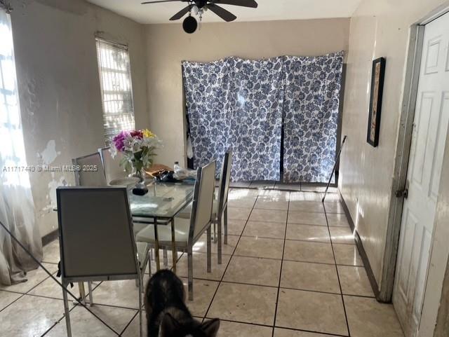 tiled dining room featuring ceiling fan