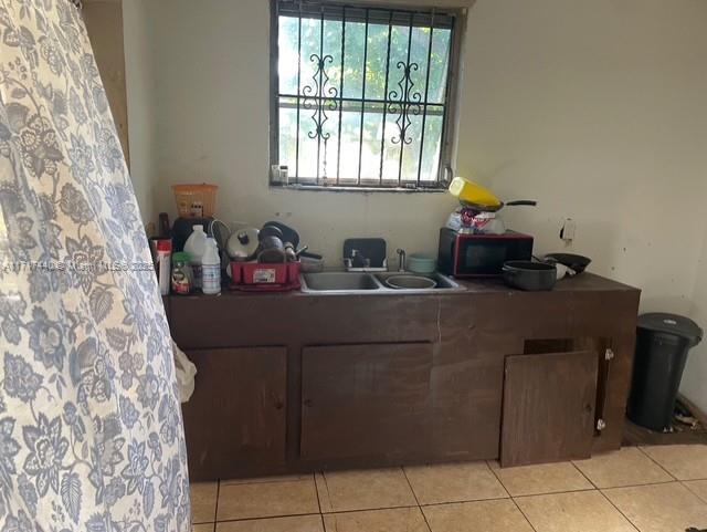 office with sink and light tile patterned floors