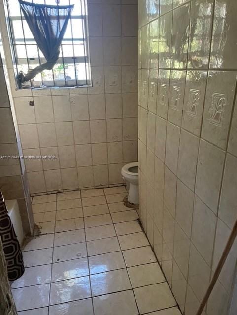 bathroom with tile patterned flooring and toilet