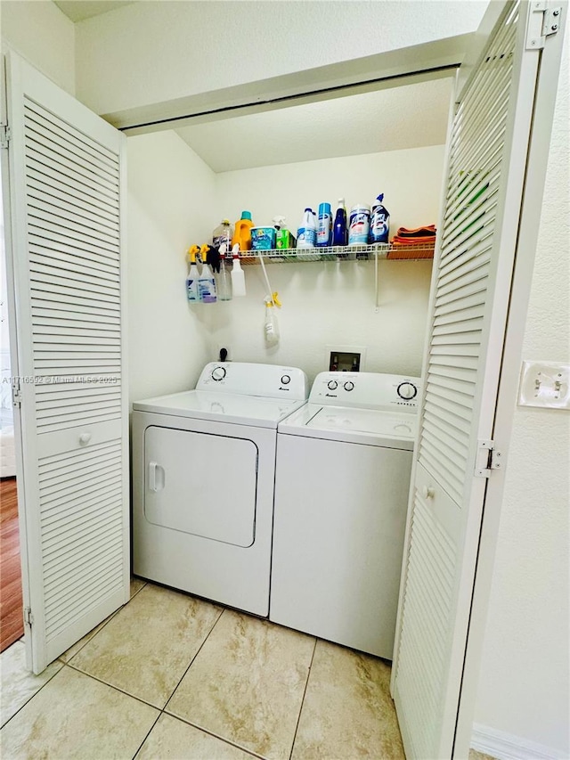 laundry room with separate washer and dryer and light tile patterned floors