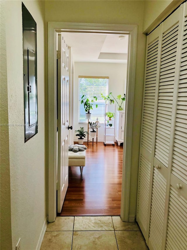 corridor featuring light tile patterned floors