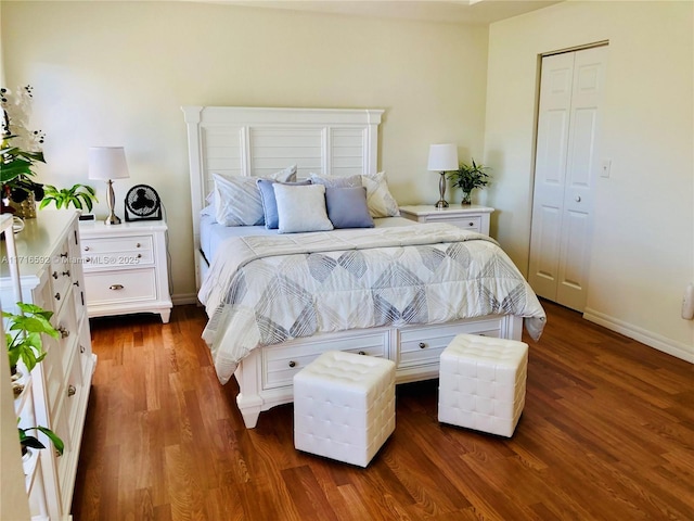 bedroom with dark hardwood / wood-style floors and a closet