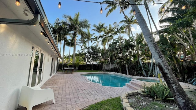 view of pool featuring an in ground hot tub and a patio