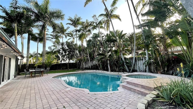 view of swimming pool featuring an in ground hot tub and a patio