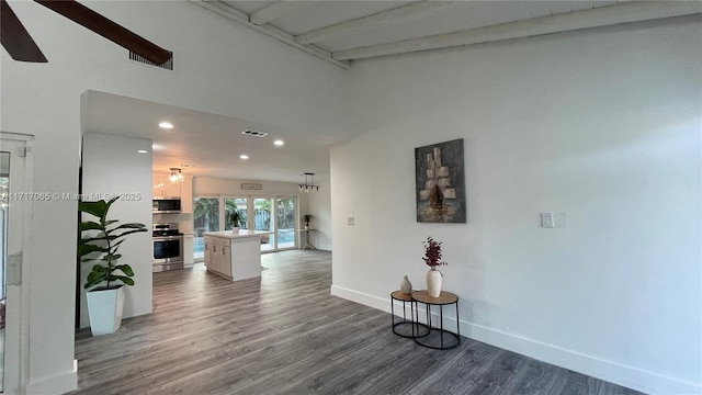 corridor with dark hardwood / wood-style flooring