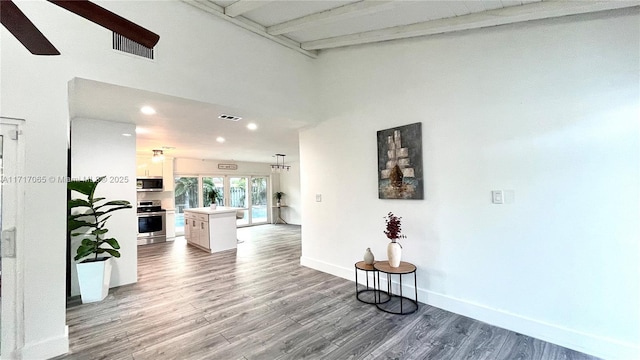 hall with beamed ceiling and dark hardwood / wood-style floors