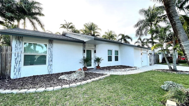 ranch-style home with a front lawn and a garage