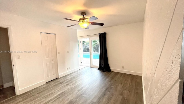 empty room featuring hardwood / wood-style flooring and ceiling fan