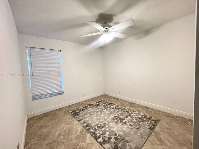 spare room with tile patterned floors and ceiling fan