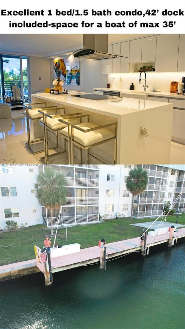 dock area featuring a water view and a sink