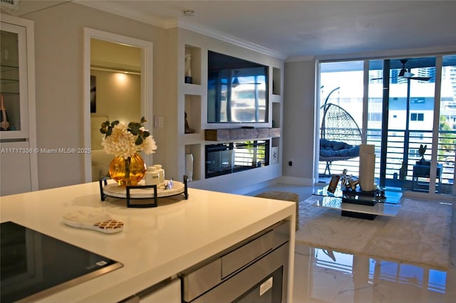 kitchen with ceiling fan, open floor plan, black electric cooktop, crown molding, and a wall of windows