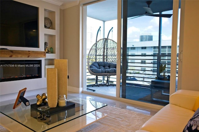 3849 NE 169th St Unit 302, North Miami Beach, FL 33160 - living area featuring healthy amount of natural light, crown molding, a wall of windows, and a glass covered fireplace