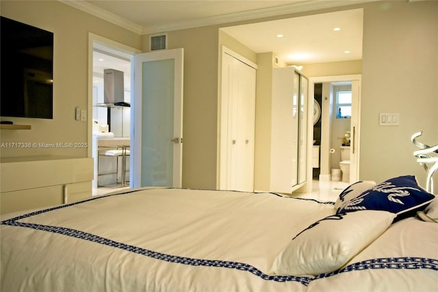 bedroom featuring connected bathroom and ornamental molding