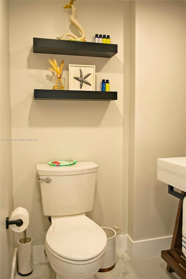 3849 NE 169th St Unit 302, North Miami Beach, FL 33160 - bathroom featuring baseboards and marble finish flooring