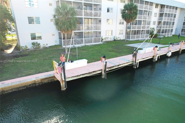 view of dock featuring a yard and a water view