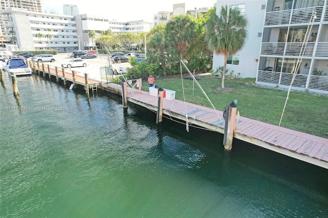 3849 NE 169th St Unit 302, North Miami Beach, FL 33160 - dock area with a water view and a lawn