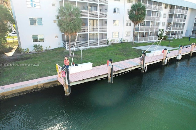 3849 NE 169th St Unit 302, North Miami Beach, FL 33160 - dock featuring a water view and a lawn