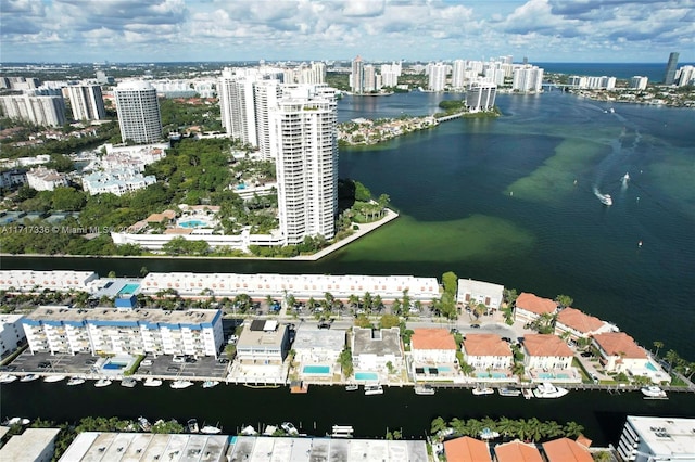 birds eye view of property featuring a water view and a city view