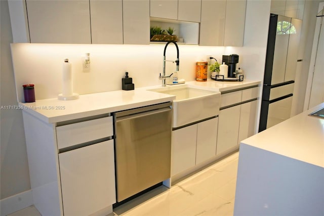 3849 NE 169th St Unit 302, North Miami Beach, FL 33160 - kitchen featuring dishwasher, white cabinets, modern cabinets, light countertops, and light marble finish flooring