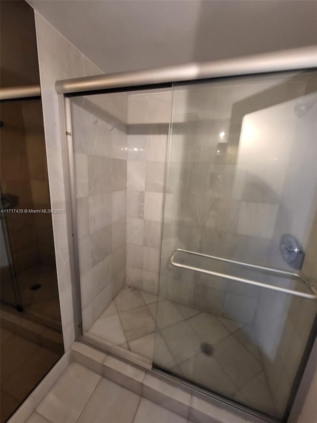 bathroom featuring tile patterned floors and an enclosed shower