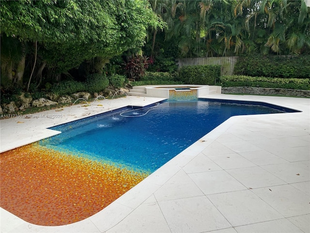 view of pool with an in ground hot tub and a patio