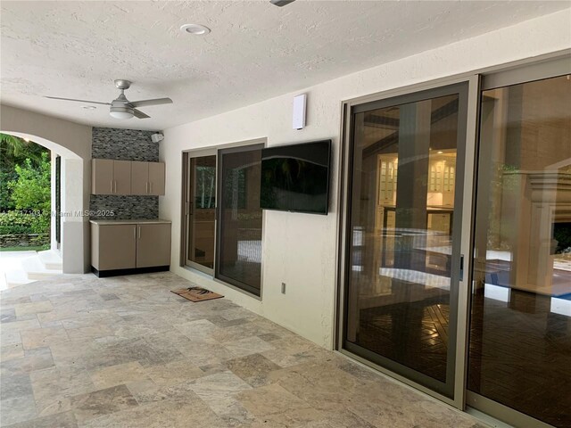 view of patio featuring ceiling fan