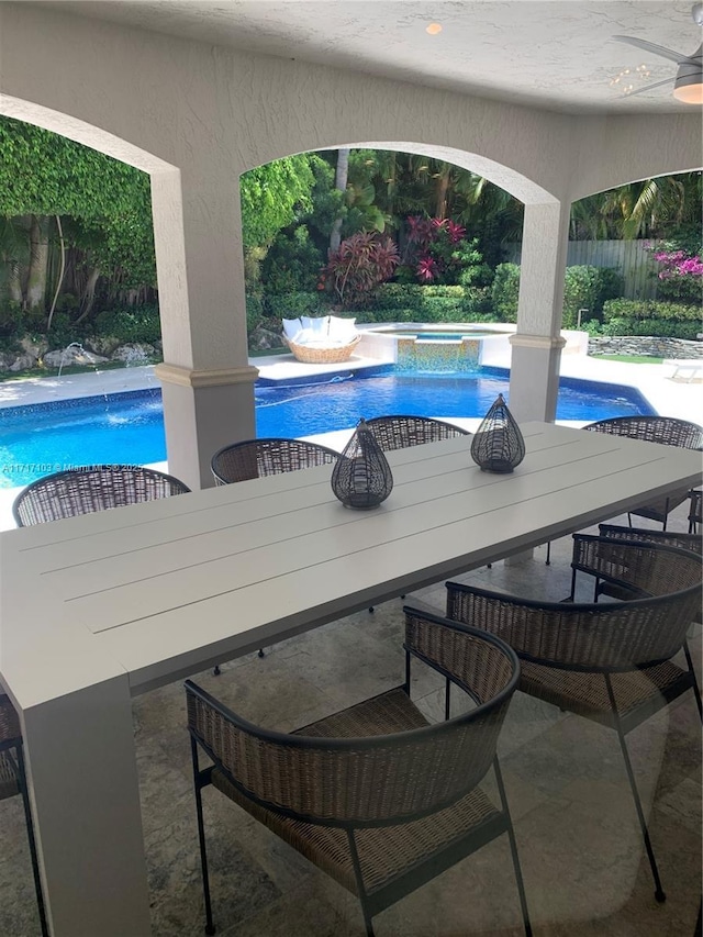 view of swimming pool featuring a patio area, an in ground hot tub, and pool water feature