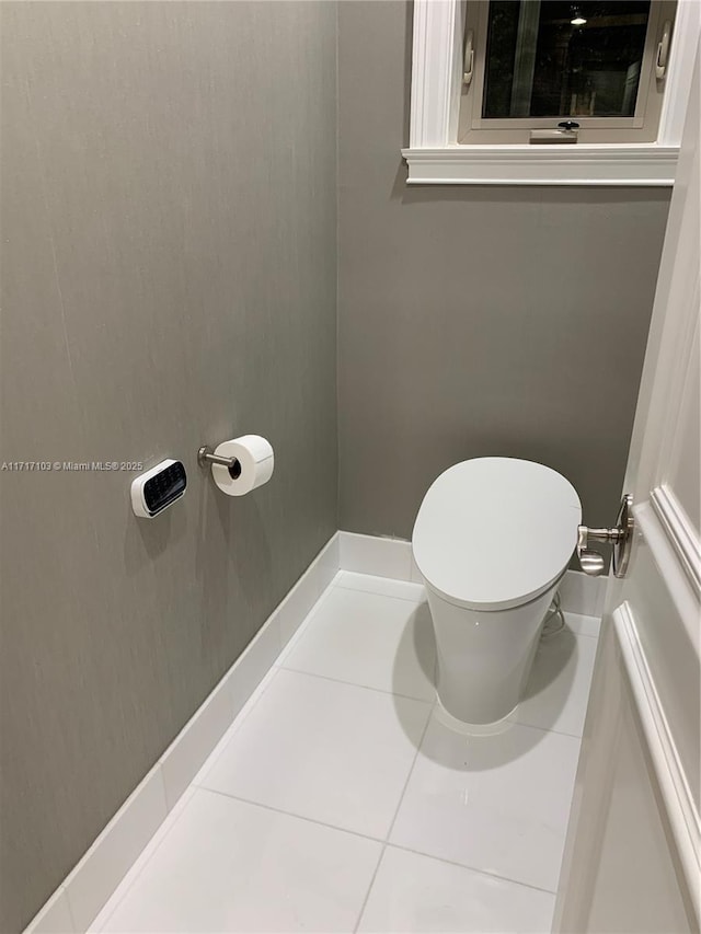 bathroom with tile patterned flooring and toilet