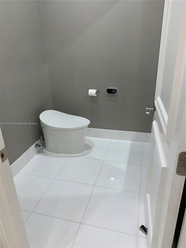 bathroom with tile patterned flooring and toilet