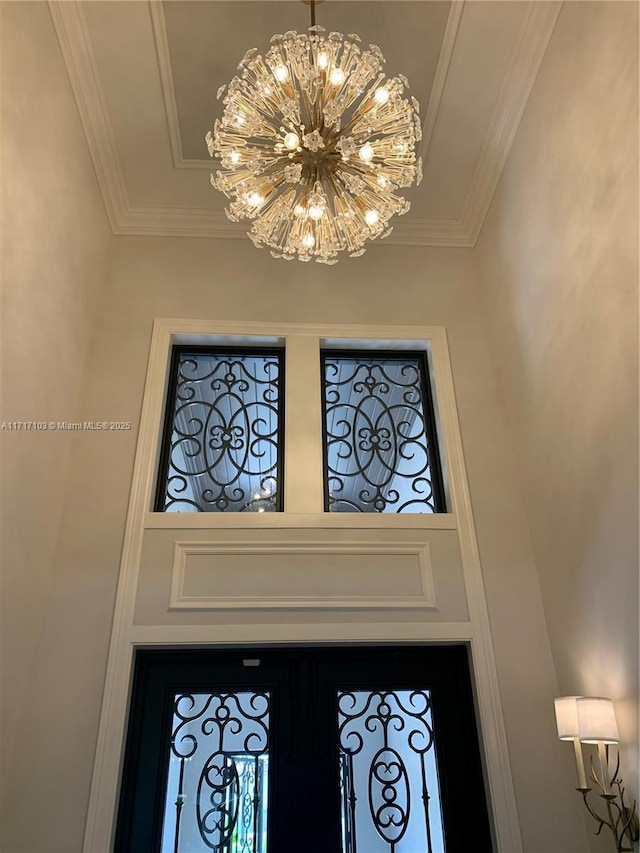 room details with ornamental molding and an inviting chandelier