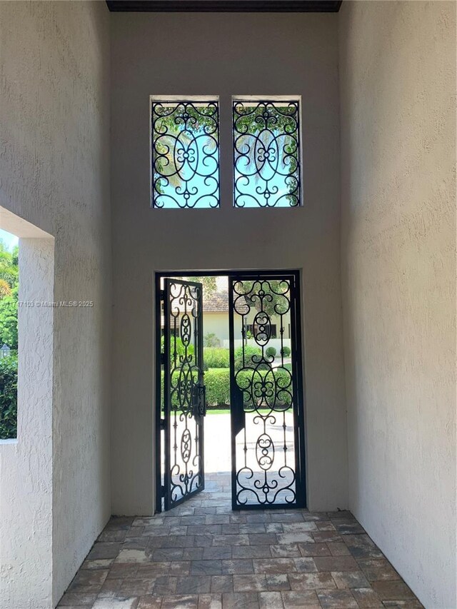 details featuring french doors, ornamental molding, and a notable chandelier