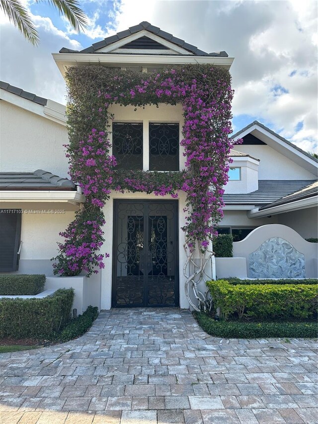 view of exterior entry featuring french doors