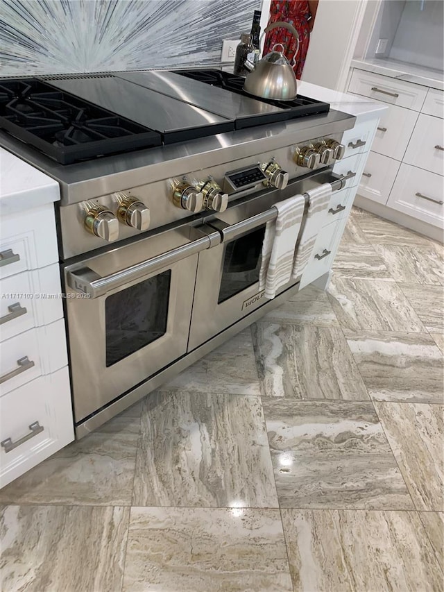 kitchen featuring white cabinetry and double oven range