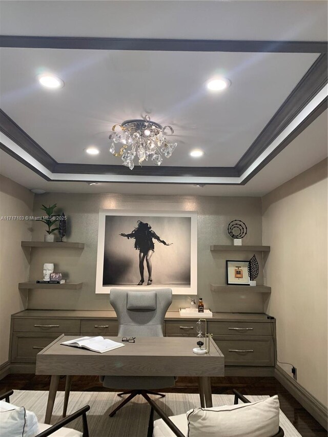 home office with crown molding, a tray ceiling, and hardwood / wood-style flooring