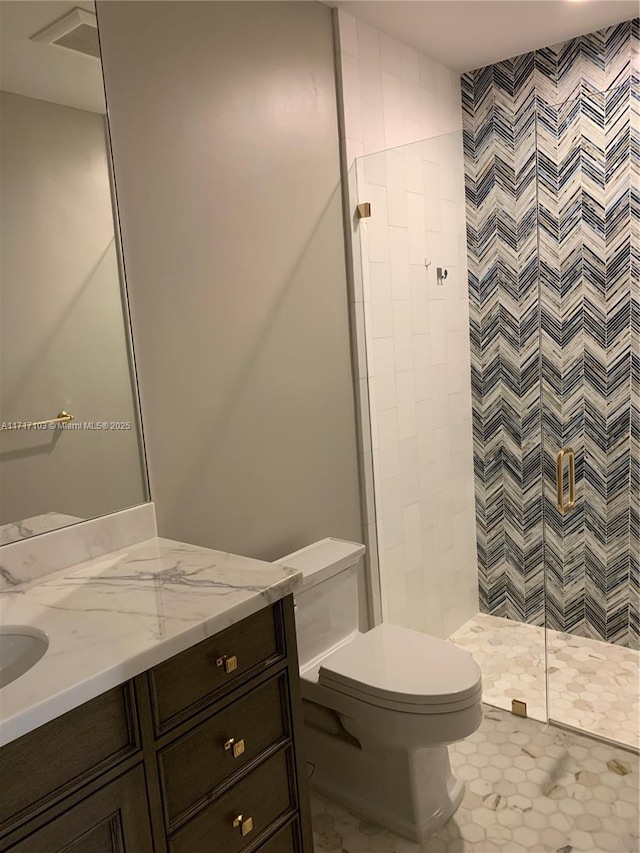 bathroom featuring tile patterned floors, vanity, toilet, and a shower