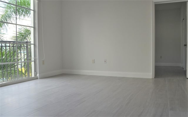 spare room featuring tile patterned floors and a wealth of natural light