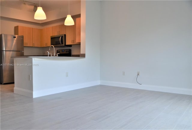 kitchen with hanging light fixtures, kitchen peninsula, light brown cabinetry, light tile patterned floors, and appliances with stainless steel finishes